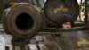 A Ukrainian soldier looks out from a 2S1 Gvozdika self-propelled howitzer on the front line in the Donetsk region on October 10.