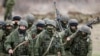 Ukraine - Uniformed men, believed to be Russian servicemen, march outside a Ukrainian military base in the village of Perevalnoye outside Simferopol, March 5, 2014