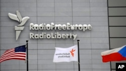 Flags fly out front of Radio Free Europe/Radio Liberty's headquarters in Prague. (file photo)