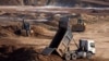 Workers extract the rare earth mineral ilmenite from an open pit mine in Ukraine's central Kirovohrad region. 