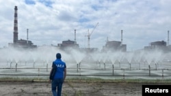 An expert from the International Atomic Energy Agency takes part in an inspection of Ukraine's Zaporizhzhya nuclear power plant, which was seized by Russian forces in MArch 2022. (file photo)